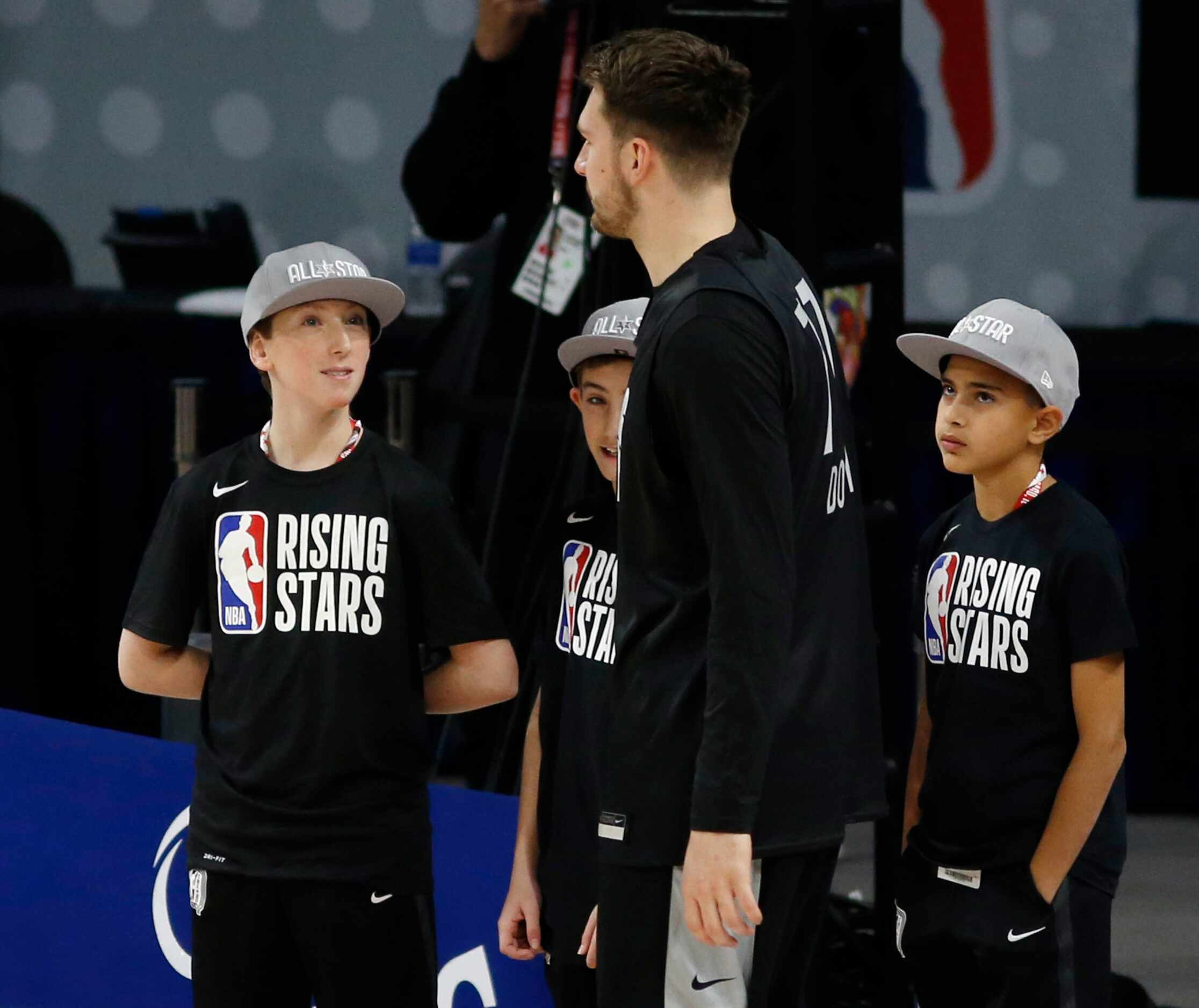 Kids look up to Dallas Mavericks forward Luka Doncic (77) as he walks by during the NBA...