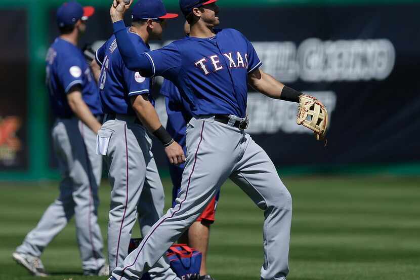 Texas Rangers' Joey Gallo throws prior to a spring training exhibition baseball game against...