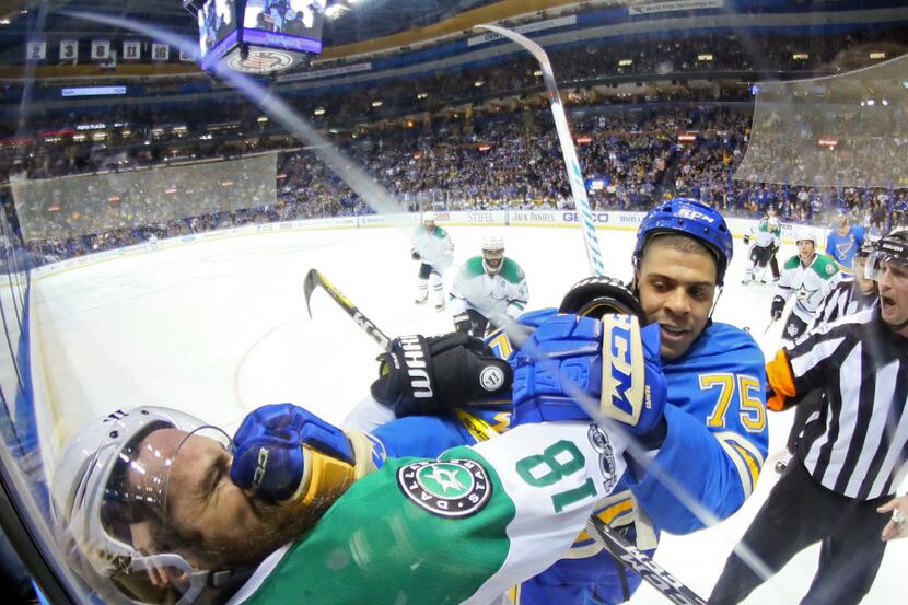 St. Louis Blues right wing Ryan Reaves tangles with Dallas Stars right wing Patrick Eaves...