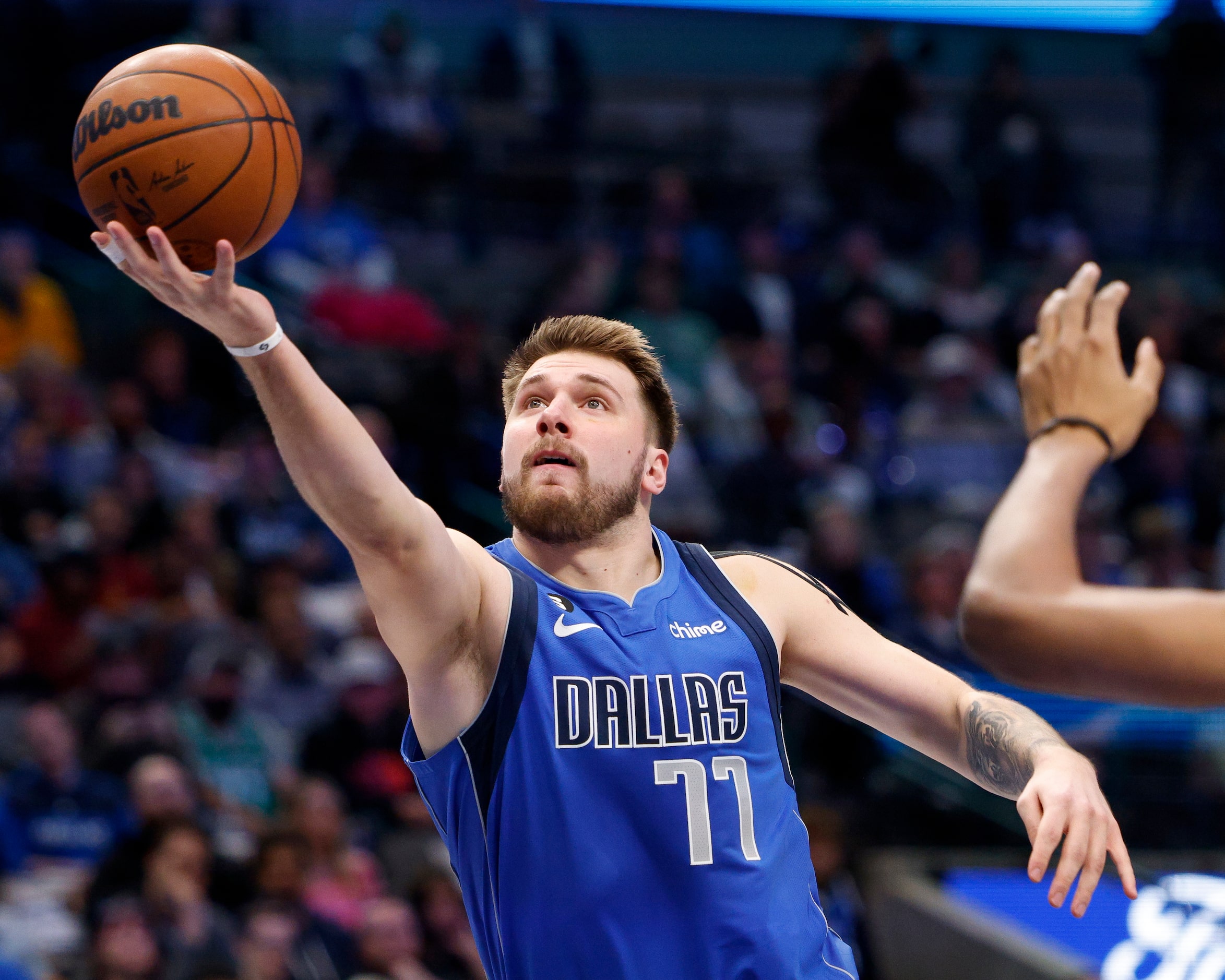 Dallas Mavericks guard Luka Doncic (77) lays the ball up during the first half of an NBA...