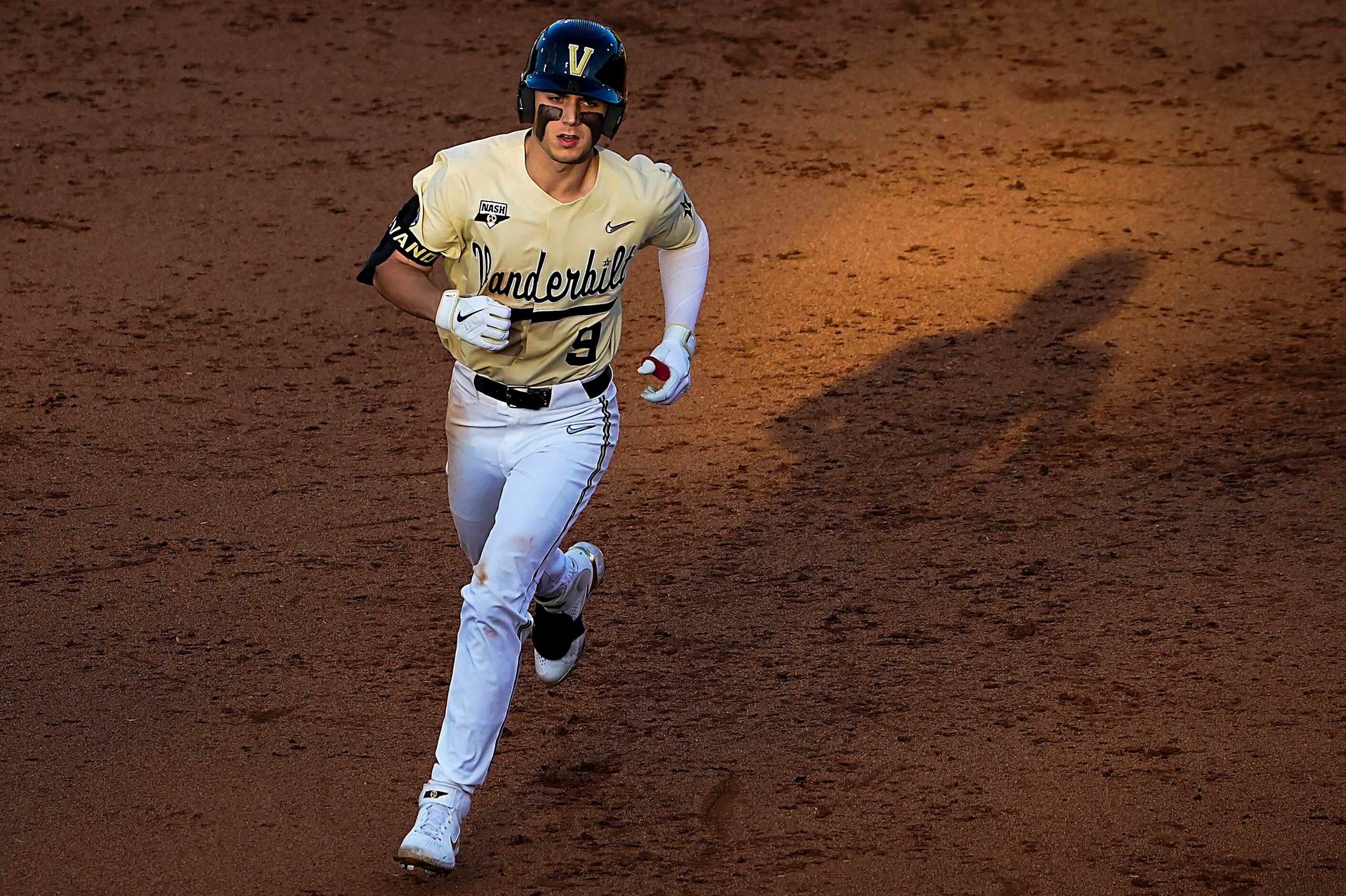 Vanderbilt infielder Carter Young rounds the bases after hitting on or the Commodores seven...