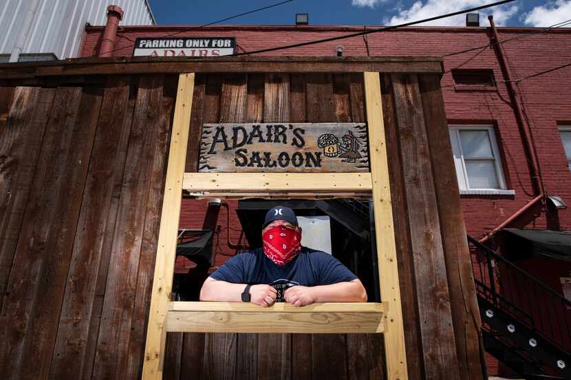 Owner Joel Morales of Adair's Saloon poses at his drive-through window on Sunday, July 19,...