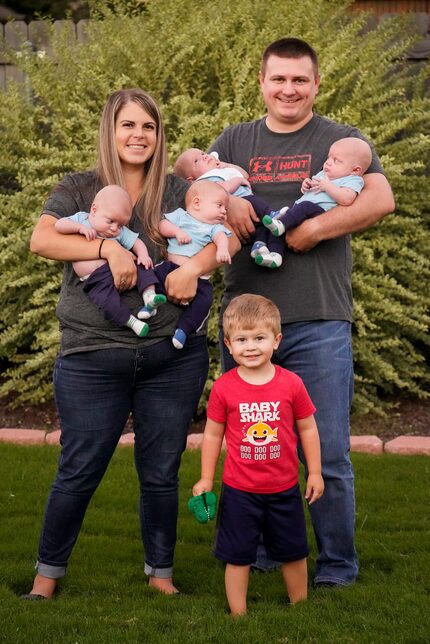 Katie and Chris Sturm with their quadruplets (from left), Daniel, Austin, Hudson and Jacob,...