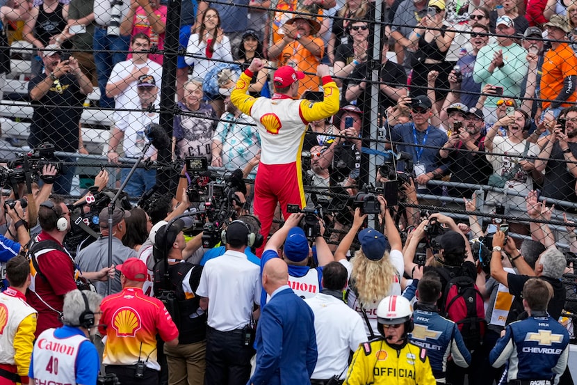 Josef Newgarden, center, celebrates after winning the Indianapolis 500 auto race at...