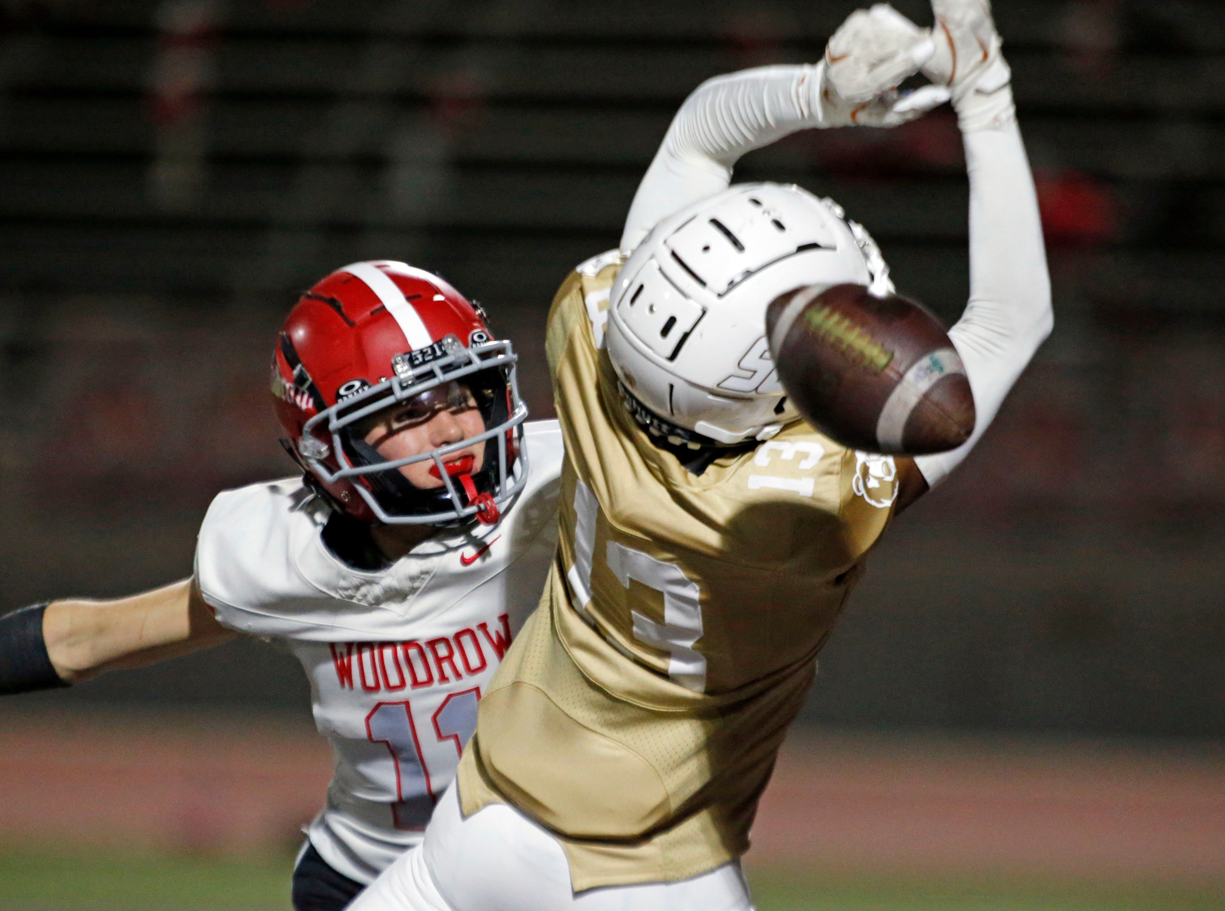 Woodrow Wilson High’s Will Holbrook (11) and South Oak Cliff High Jalen Moore (13) battle...