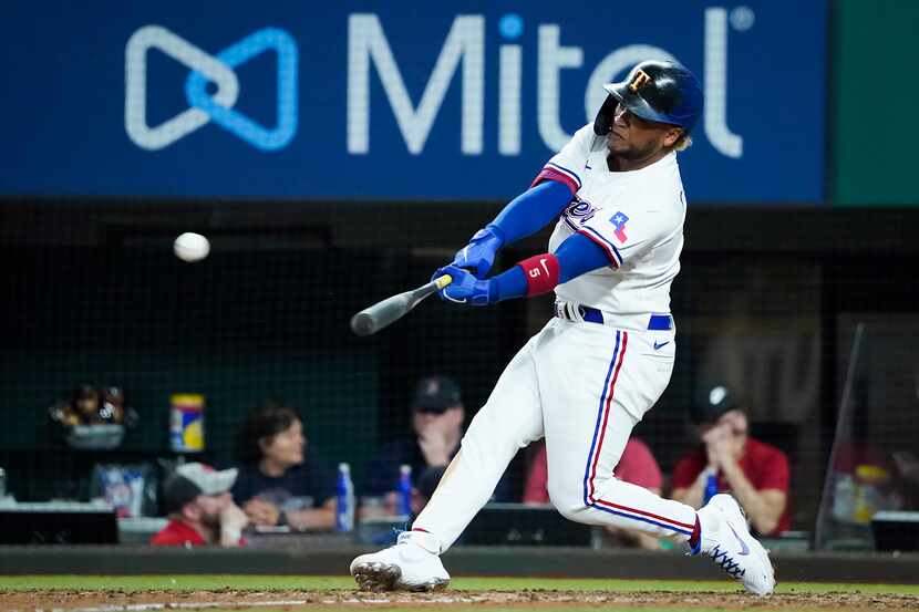 Texas Rangers designated hitter Willie Calhoun connects for a double during the eighth...