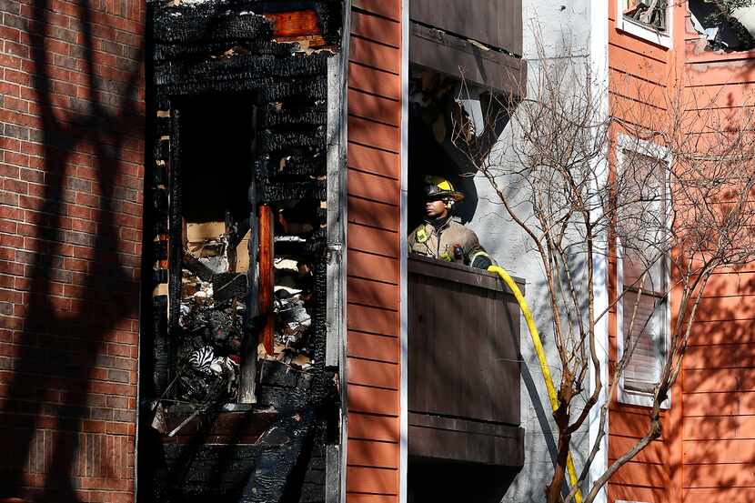 A Dallas firefighter works a 4-alarm fire at Villa Vista Apartments in Dallas, Saturday,...