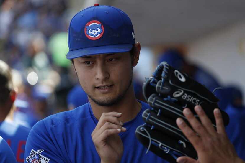 Chicago Cubs pitcher Yu Darvish greets teammate after the second inning of a spring training...