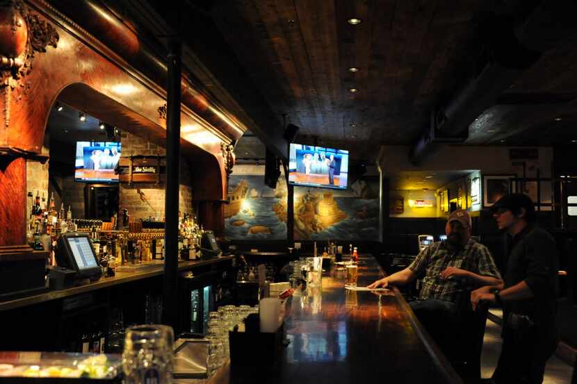 Guests sit at the bar and enjoy drinks at The Skellig on Henderson Avenue in Dallas, TX on...