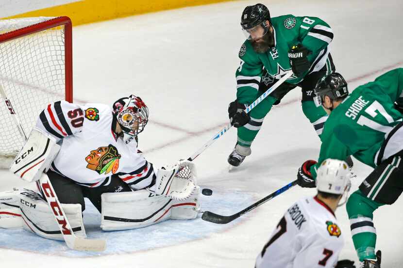 Dallas Stars Patrick Eaves (18) and Devin Shore (17) try to direct the puck past Chicago...