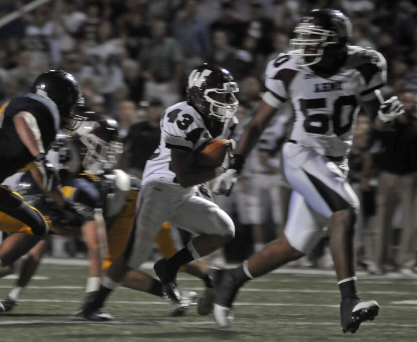 Wylie junior Kyle Fuller (50) blocks as senior Vincent Bryan (43) runs for a touchdown...