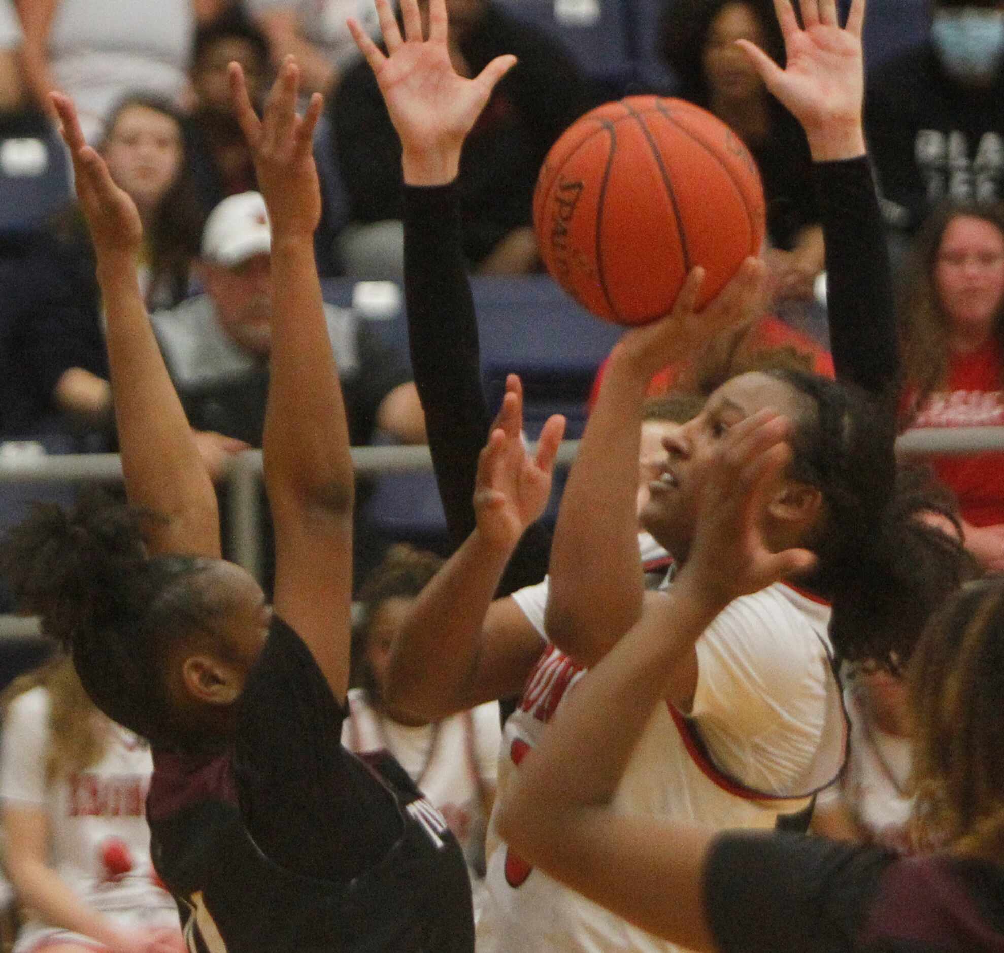 Mansfield Legacy guard Savannah Catalon (5) gets off a shot surrounded by several defenders...