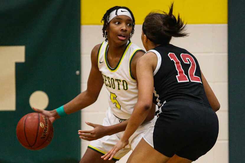 DeSoto's Sa'Myah Smith (5) tries to protect the ball against Duncanville's Zaria Rufus (12)...