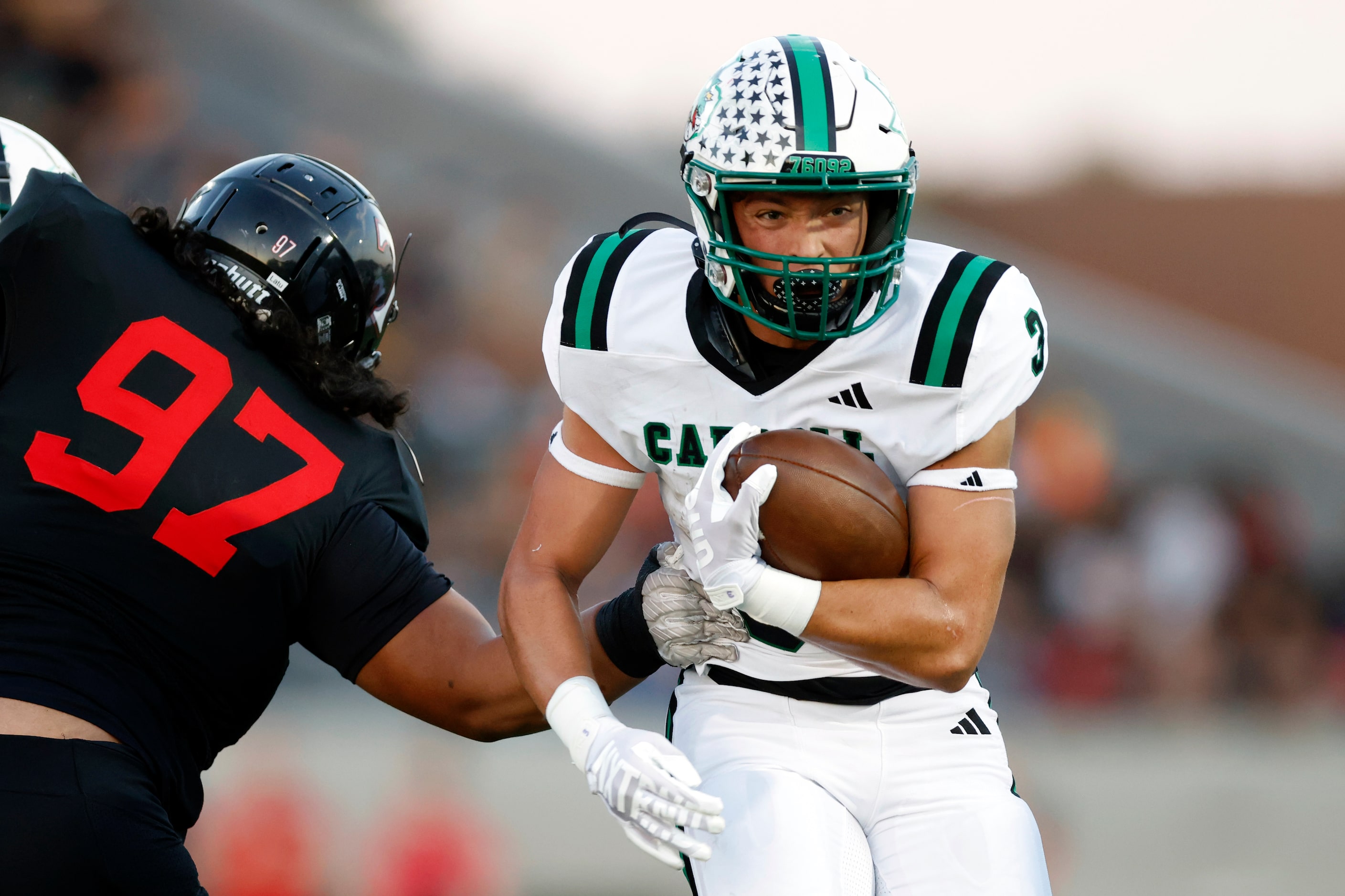 Southlake Carroll running back Davis Penn (3) runs through the arm of Euless Trinity...