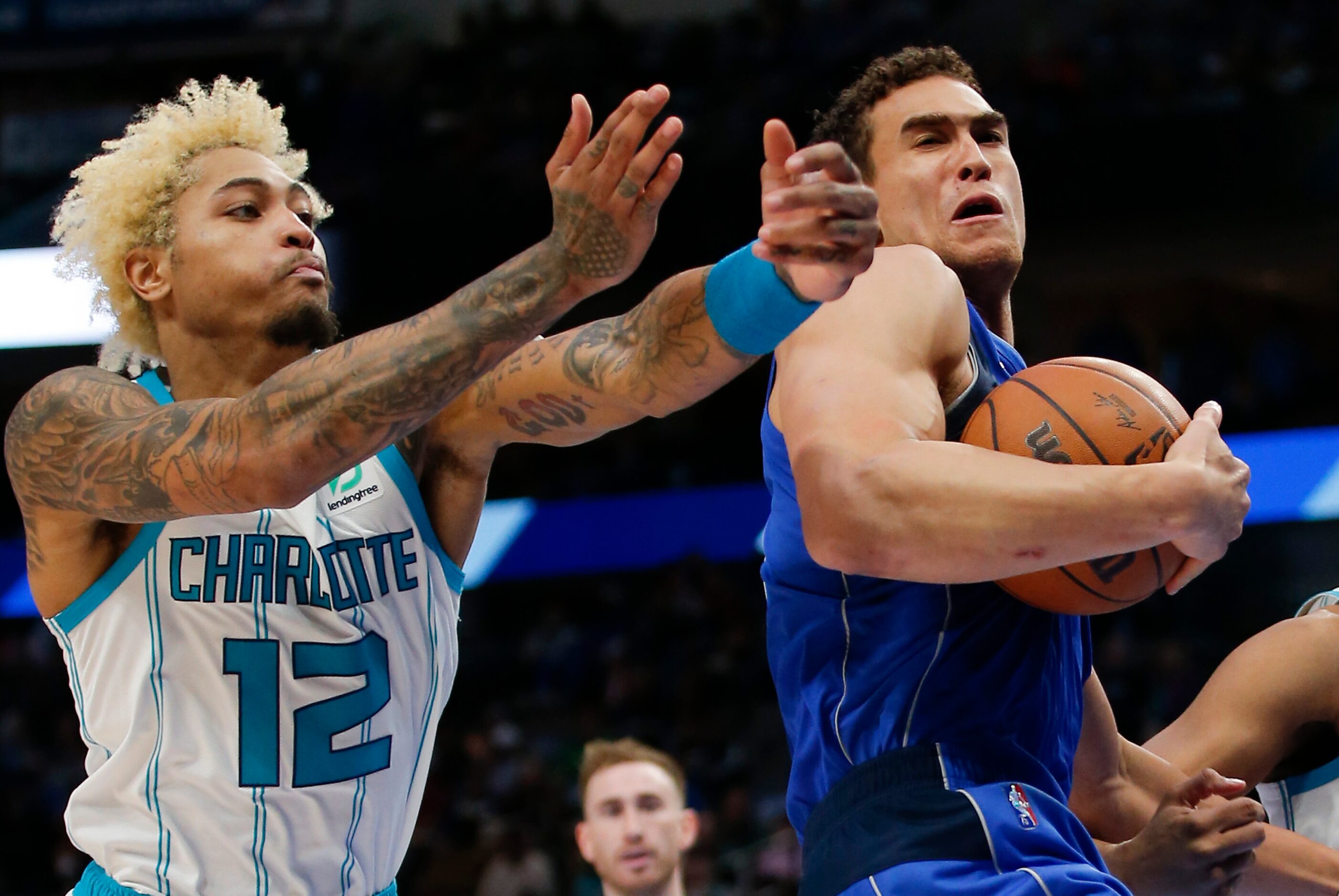 Dallas Mavericks center Dwight Powell, right, battles Charlotte Hornets guard Kelly Oubre...