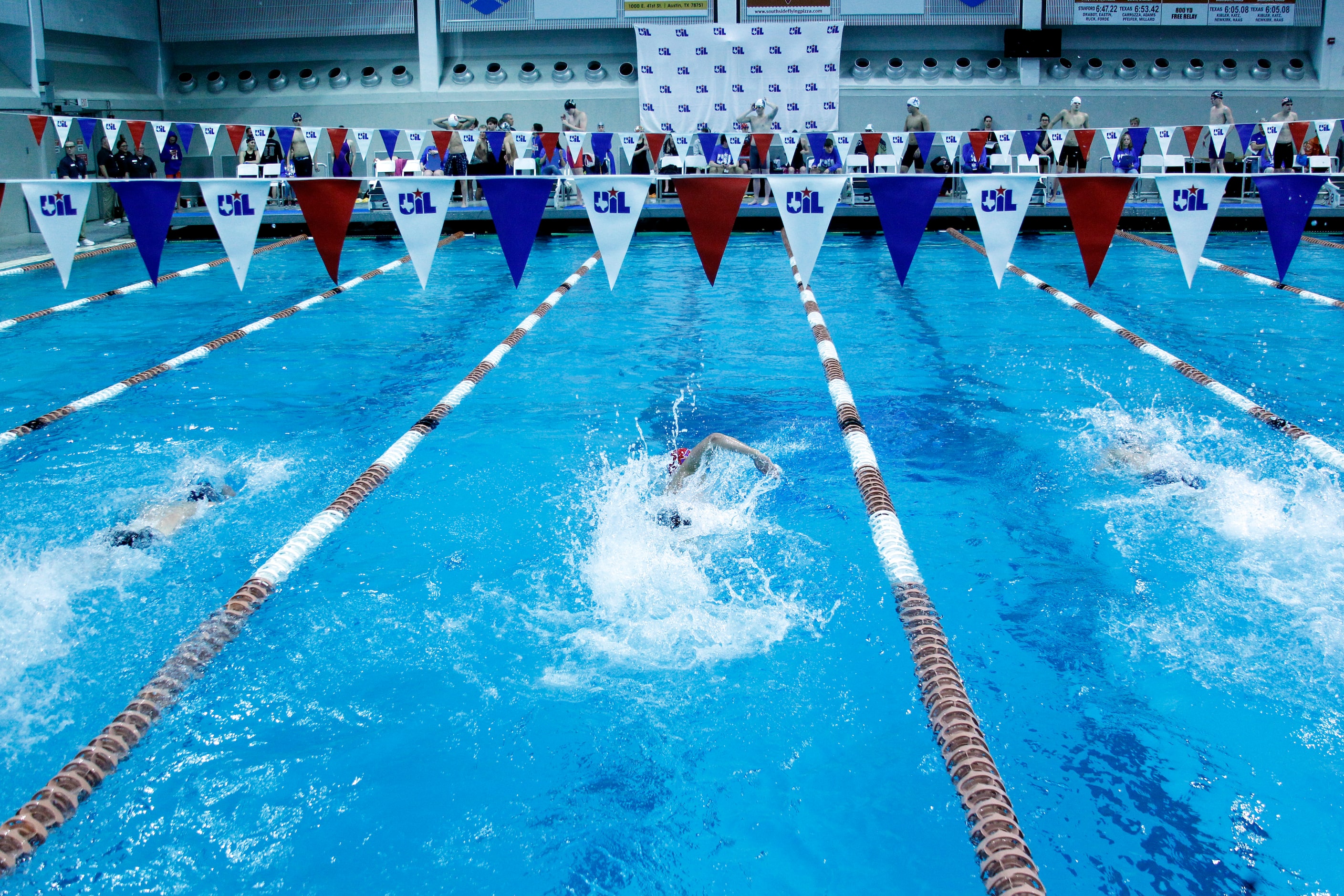 Swimmers representing schools throughout the state compete during a 6A race. The first day...