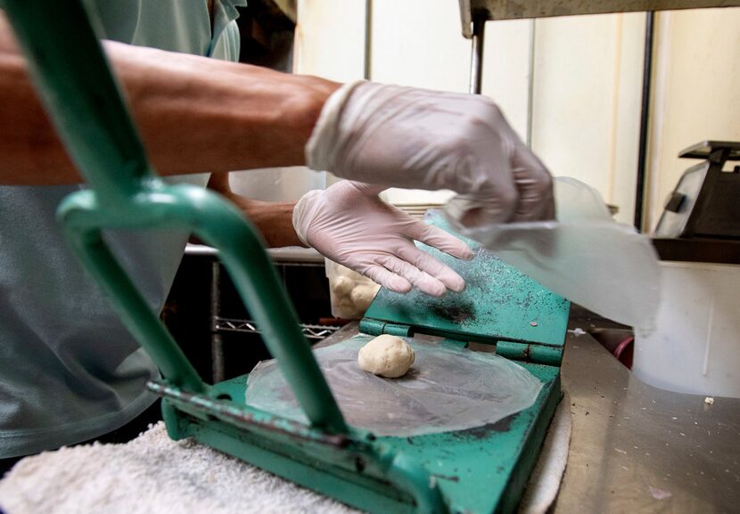 Soto uses his mother-in-law's press to make tortillas to order.