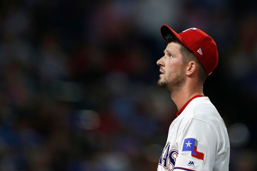 Texas Rangers pitcher Drew Smyly (33) makes his way to the dugout after getting pulled from...