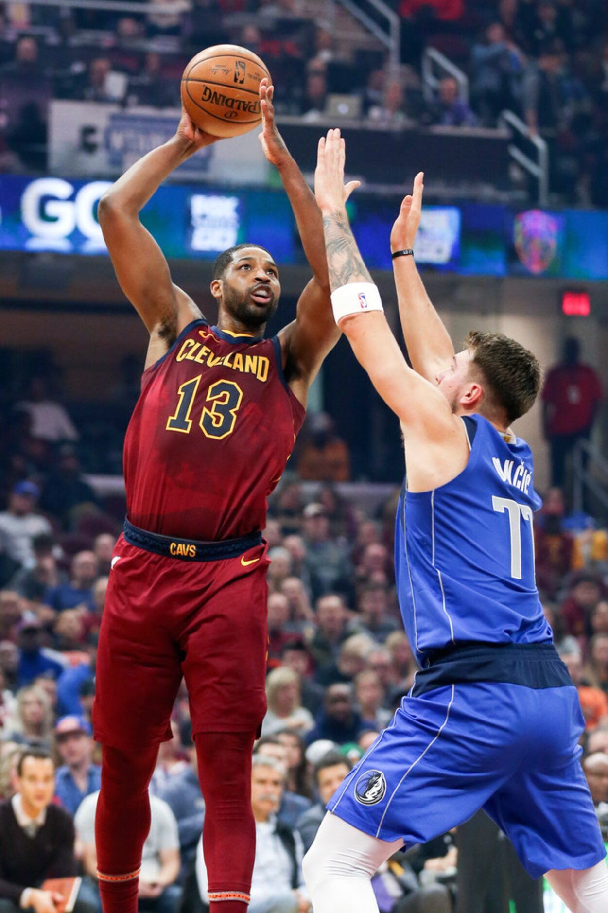 Cleveland Cavaliers' Tristan Thompson (13) shoots over Dallas Mavericks' Luka Doncic (77) in...