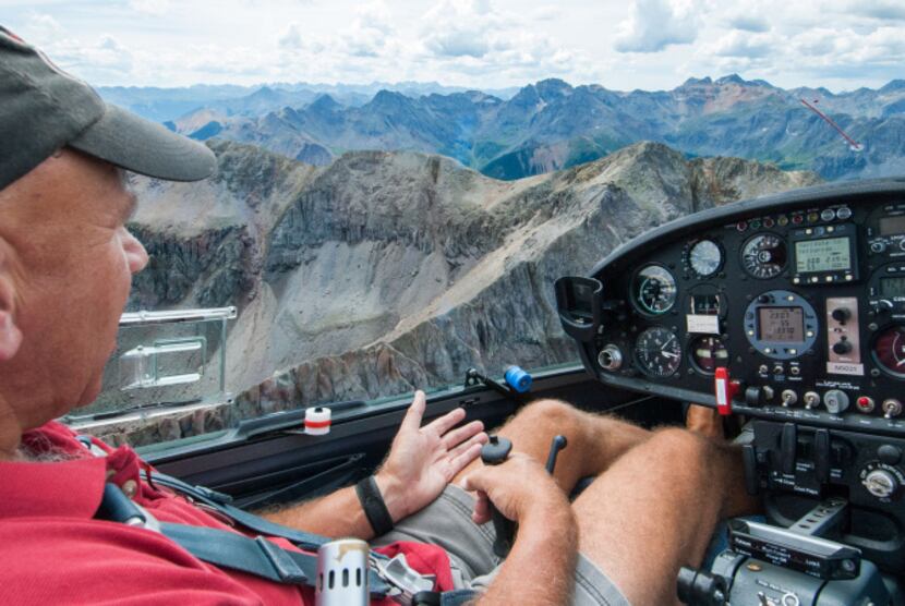 Pilot Bob Saunders sits at the controls of his glider over  Telluride, Colorado.  While the...