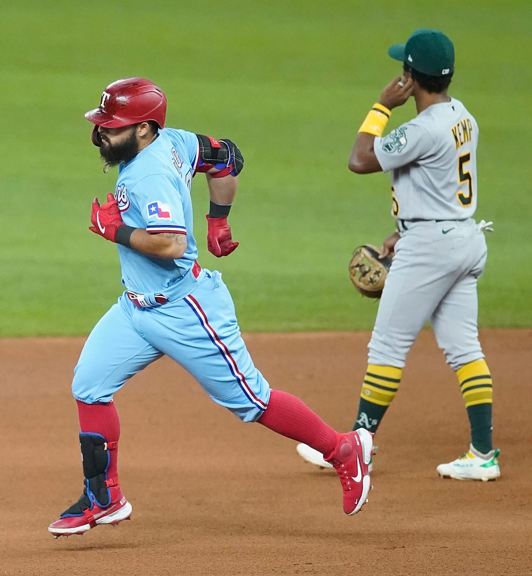 Texas Rangers second baseman Rougned Odor rounds the bases past Oakland Athletics second...