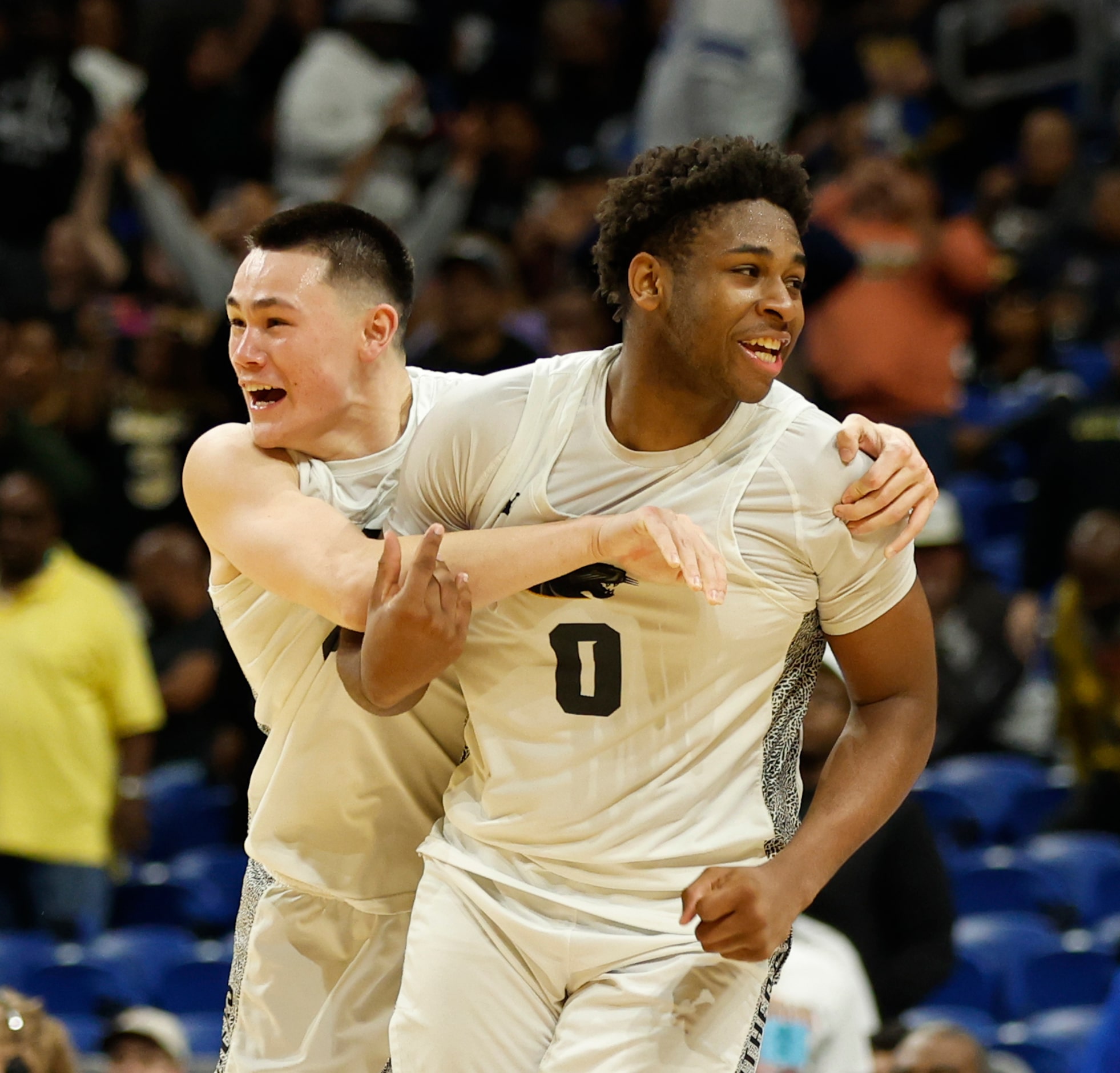 Plano East's Narit Chotikavanic (2) hugs teammate DJ Hall (0) after defeating Round Rock...