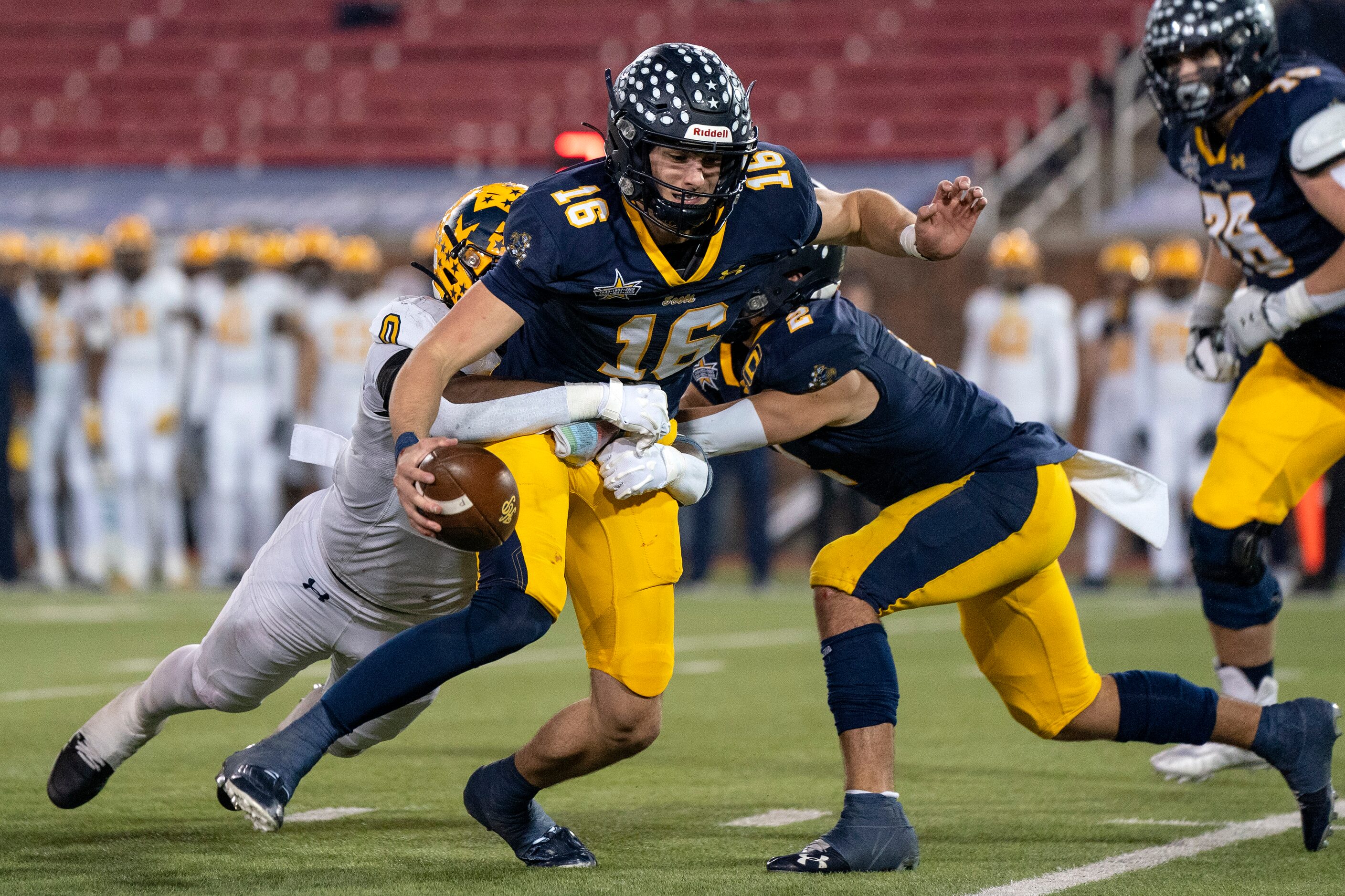 Highland Park senior quarterback Parker Thompson (16) is sacked by McKinney senior...