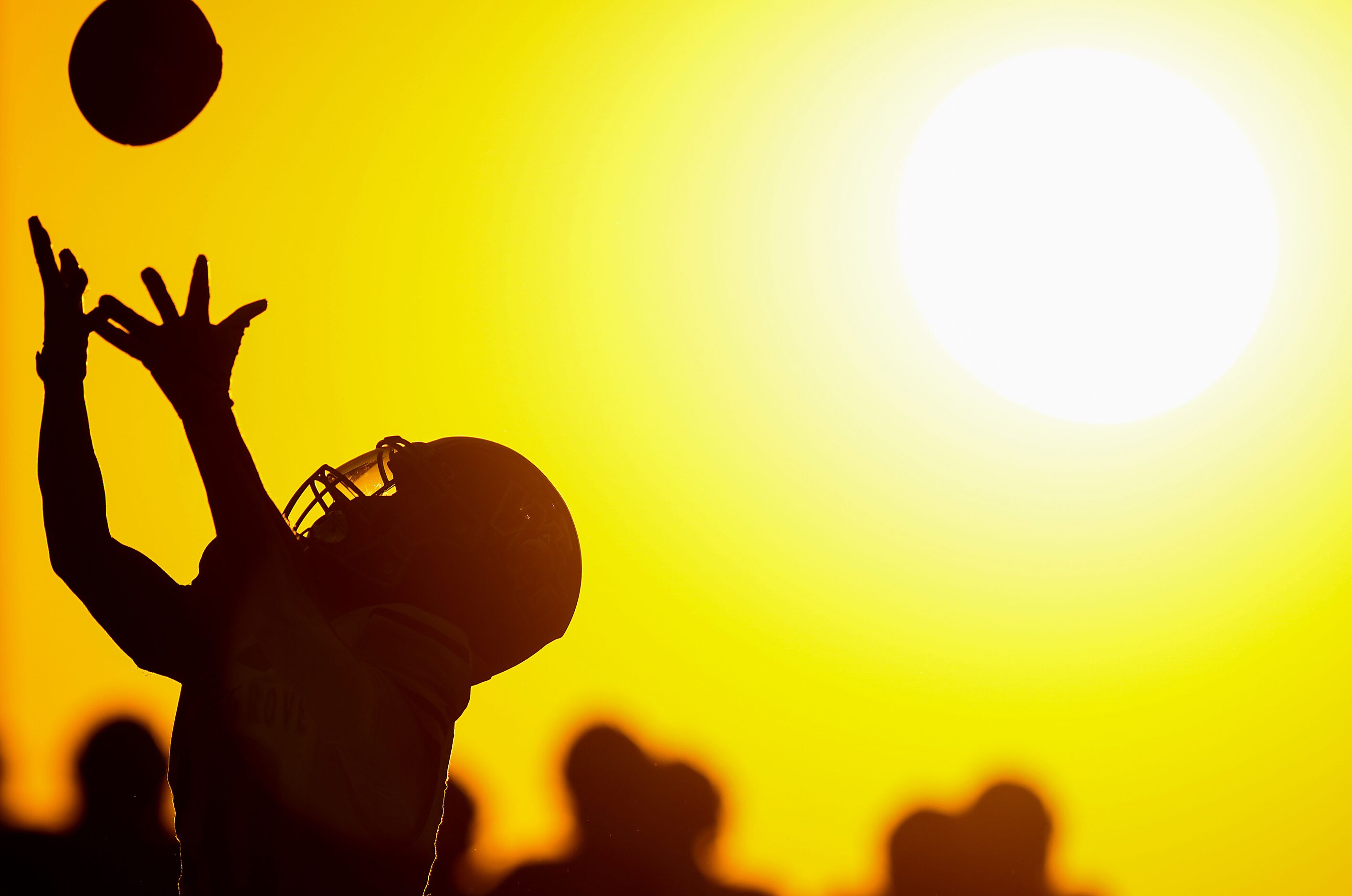 Prosper Walnut Grove wide receiver Zaiden Crain reaches for a pass as the sun sets during...