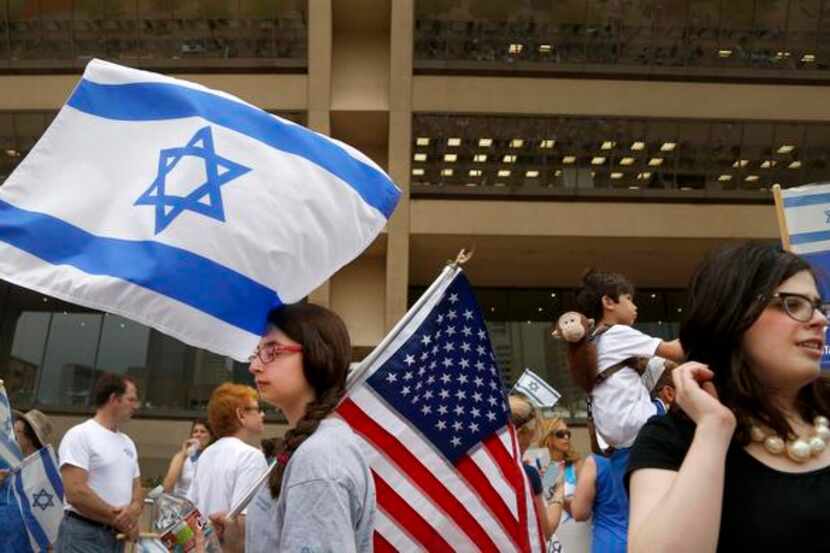 
Lily Goldberg held an American flag as others waved the Israeli flag during a pro-Israel...