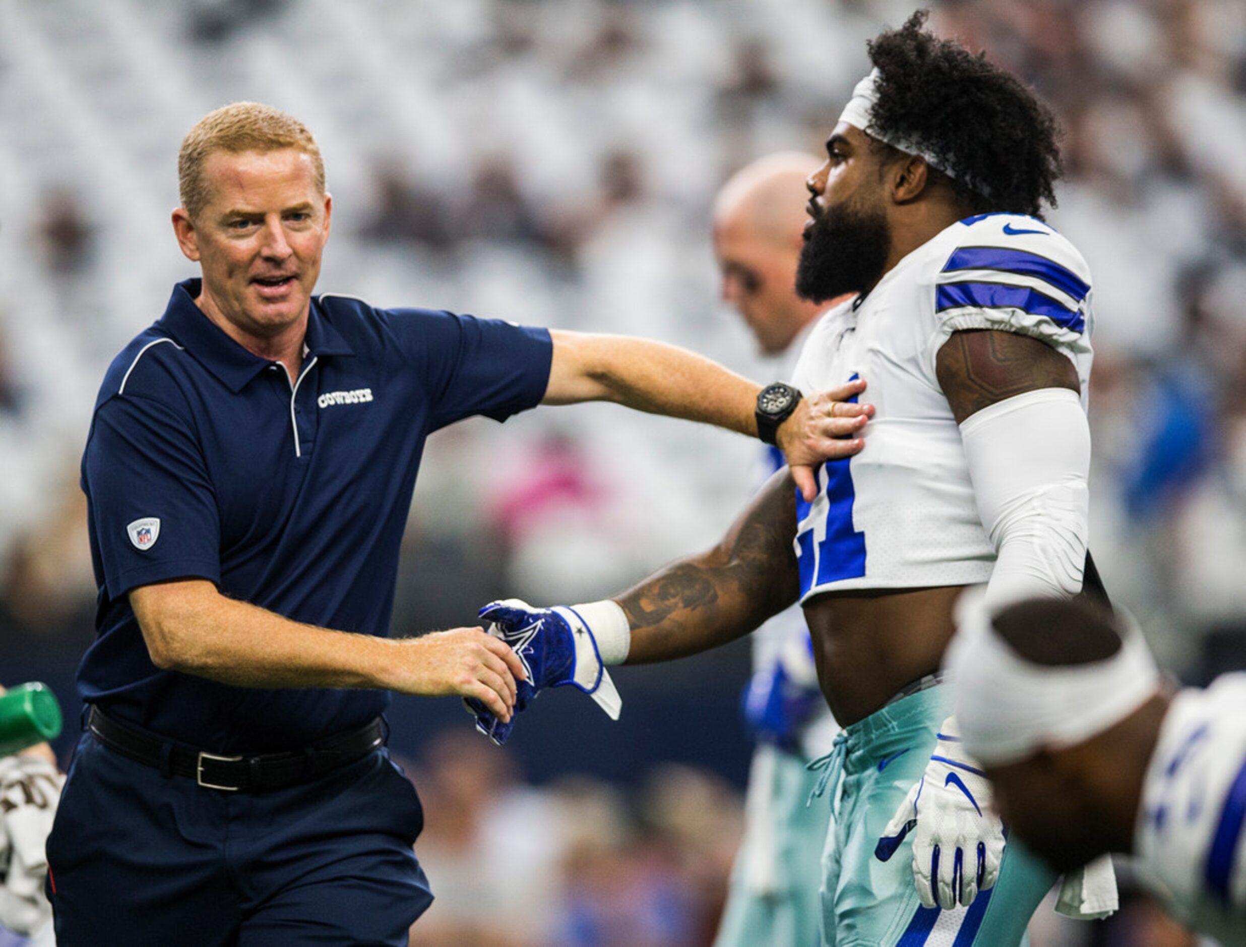 Dallas Cowboys head coach Jason Garrett shakes hands with running back Ezekiel Elliott (21)...