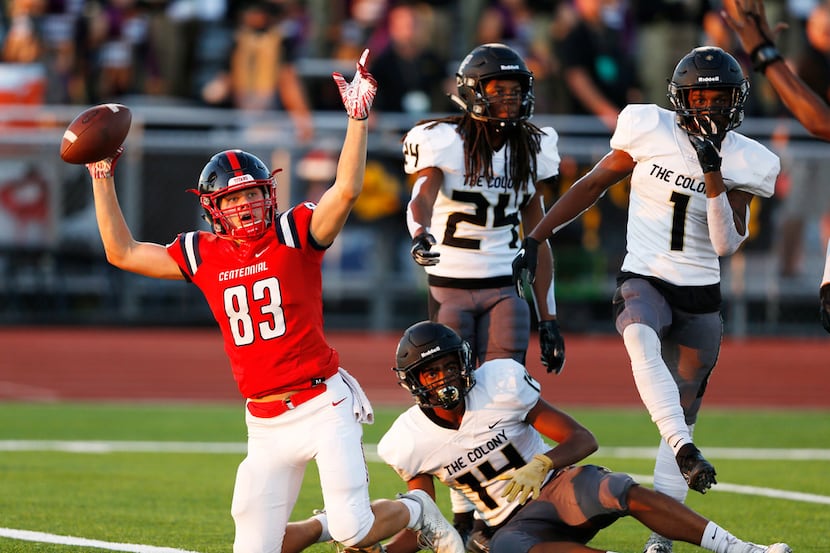 Centennial's Jacob McCoy (83) signals a touchdown after scoring a touchdown as The Colony's...