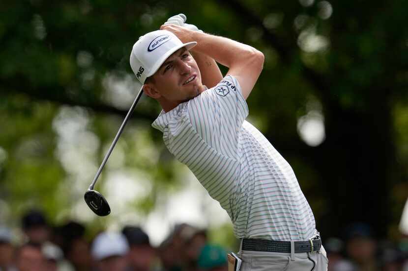 Sam Bennett watches his tee shot on the fourth hole during the second round of the Masters...