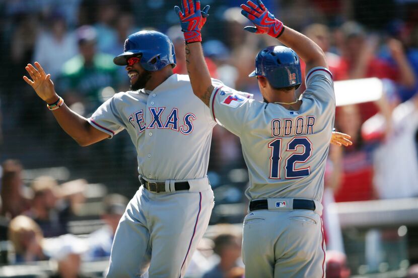 Texas Rangers pinch-runner Delino DeShields, left, celebrates with Rougned Odor after they...