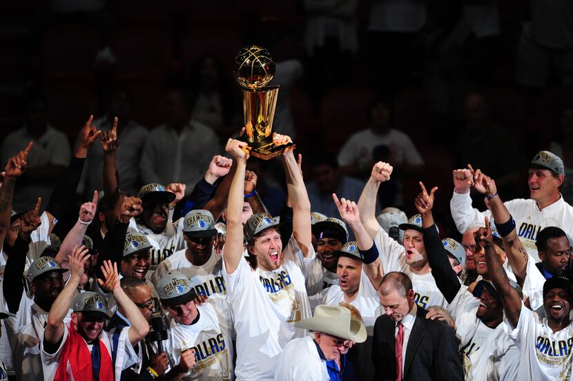 Dirk Nowitzki (C) of the Dallas Mavericks celebrates with teammates after winning the NBA...