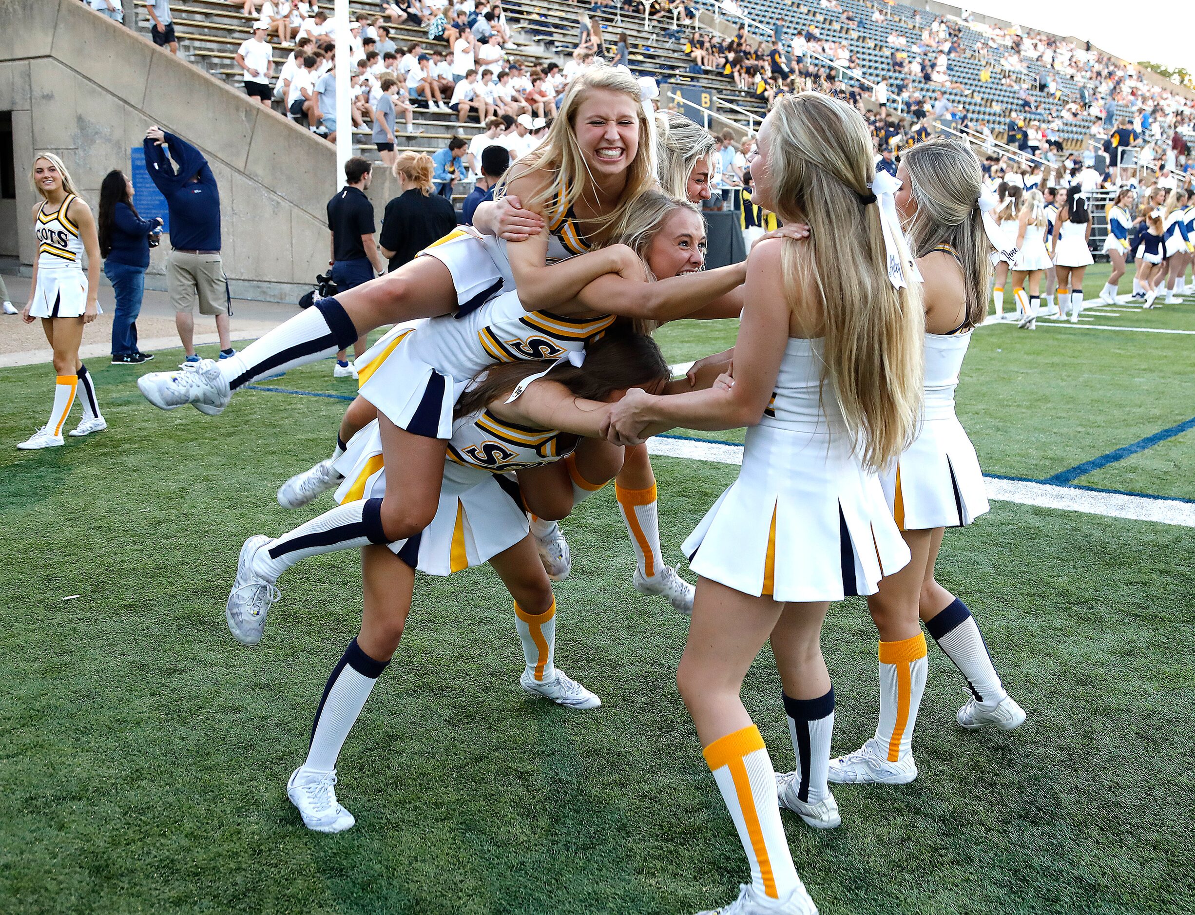 Highland Park High School cheerleader Elle Barrett (top) falls when the cheer squad tried to...