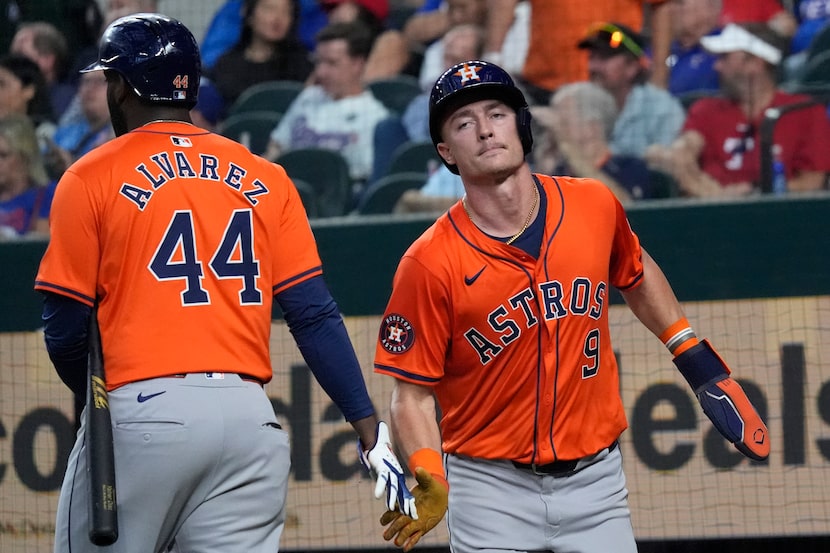 Houston Astros Zach Dezenzo (9) is congratulated by teammate Yordan Alvarez (44) after...