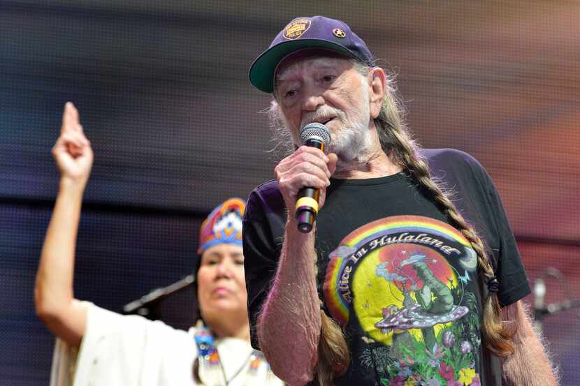 Willie Nelson recites the Lord's Prayer at Farm Aid 14 in Raleigh, N.C., Saturday, Sept. 13,...