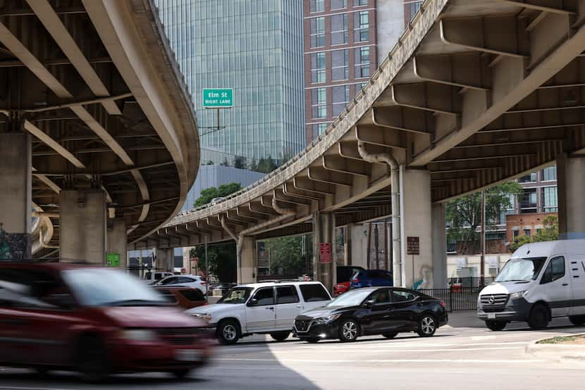 Motorists wait for a green light on Good Latimer Expressway so they can proceed under...