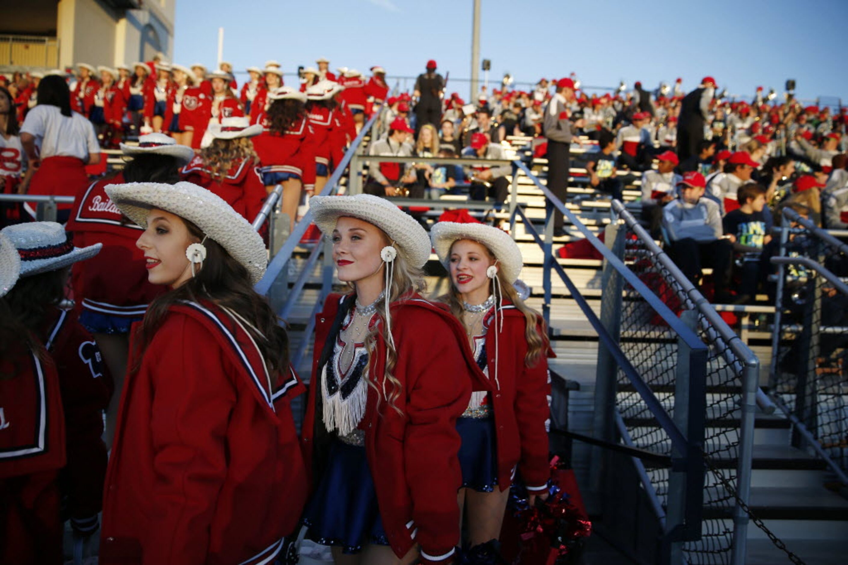 McKinney Boyd Bailadoras drill team members take their seats before a high school football...