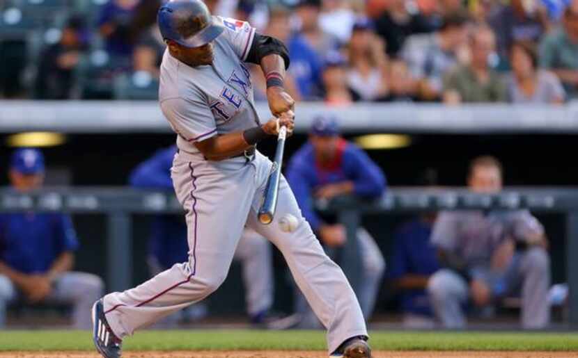 Delino DeShields #7 of the Texas Rangers hits a two RBI single in the second inning against...