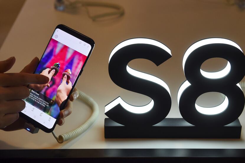 A woman tests a Samsung Galaxy S8 smartphone during a showcase to mark the domestic launch...