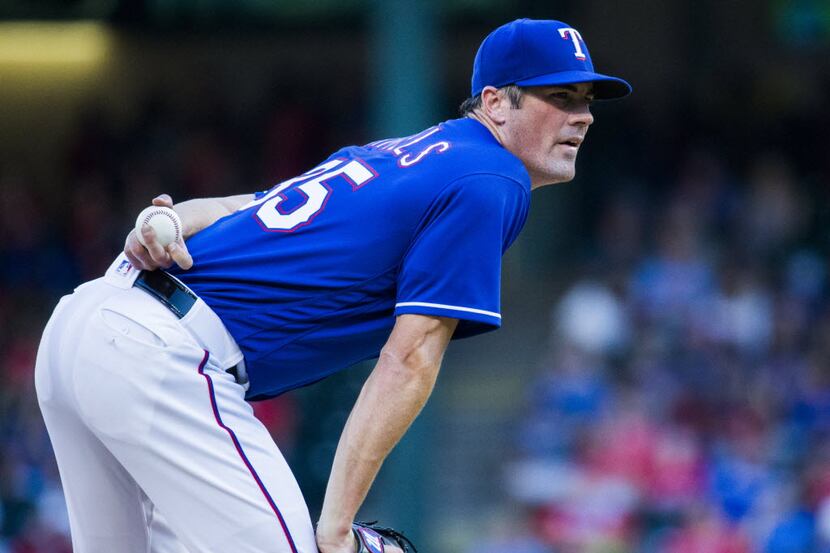 Texas Rangers starting pitcher Cole Hamels (35) looks for a signal on the mound during the...