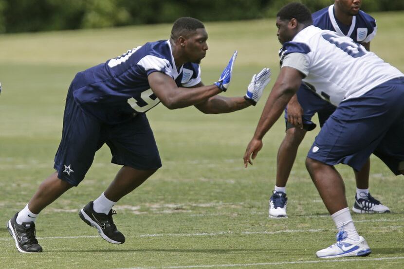 Dallas Cowboys defensive end DeMarcus Lawrence (90) is pictured as Josh Aladenoya (62) tries...