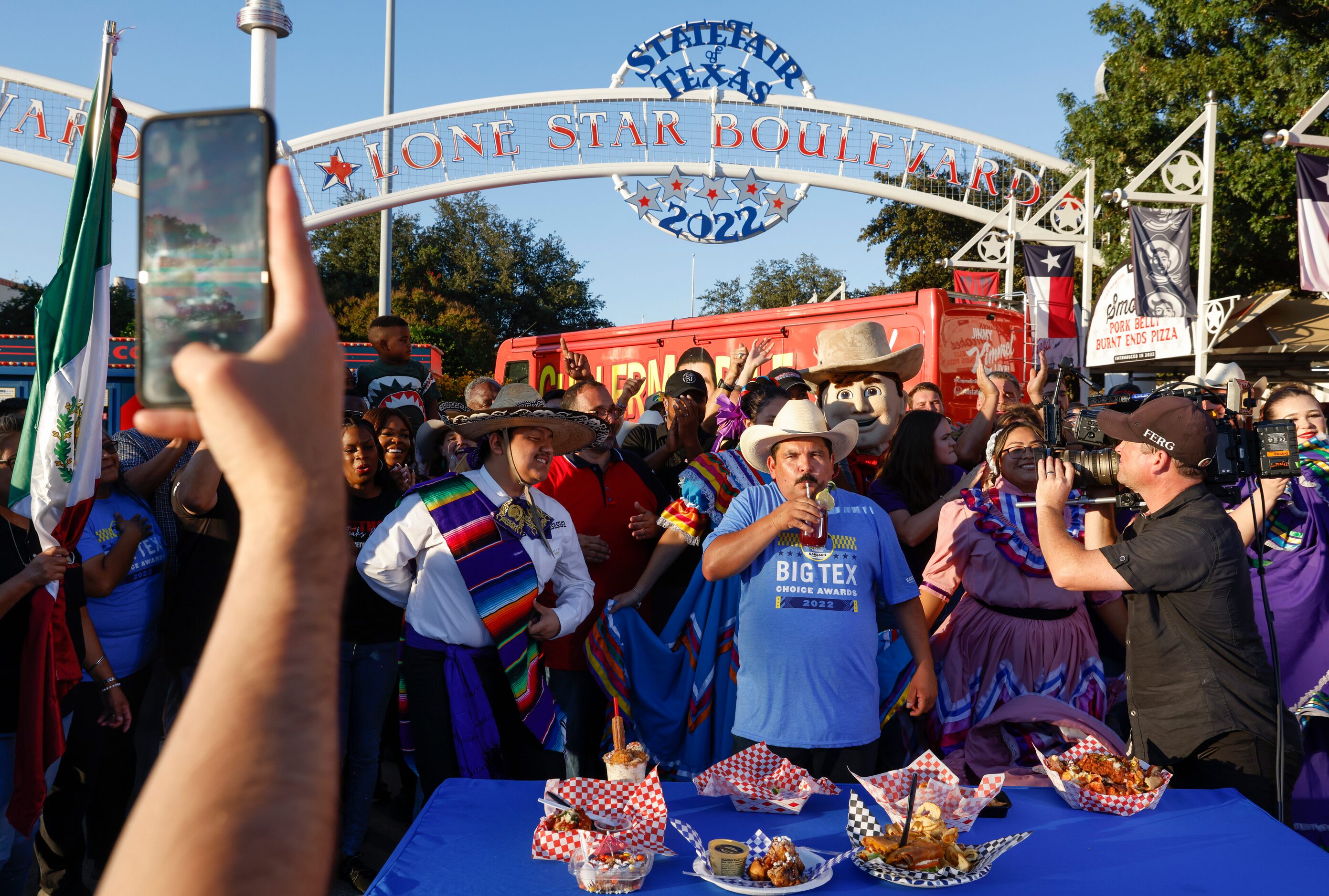 Big Tex Choice Award finalists cheer as Guillermo Rodriguez, center, tries La Bluebonnet,...