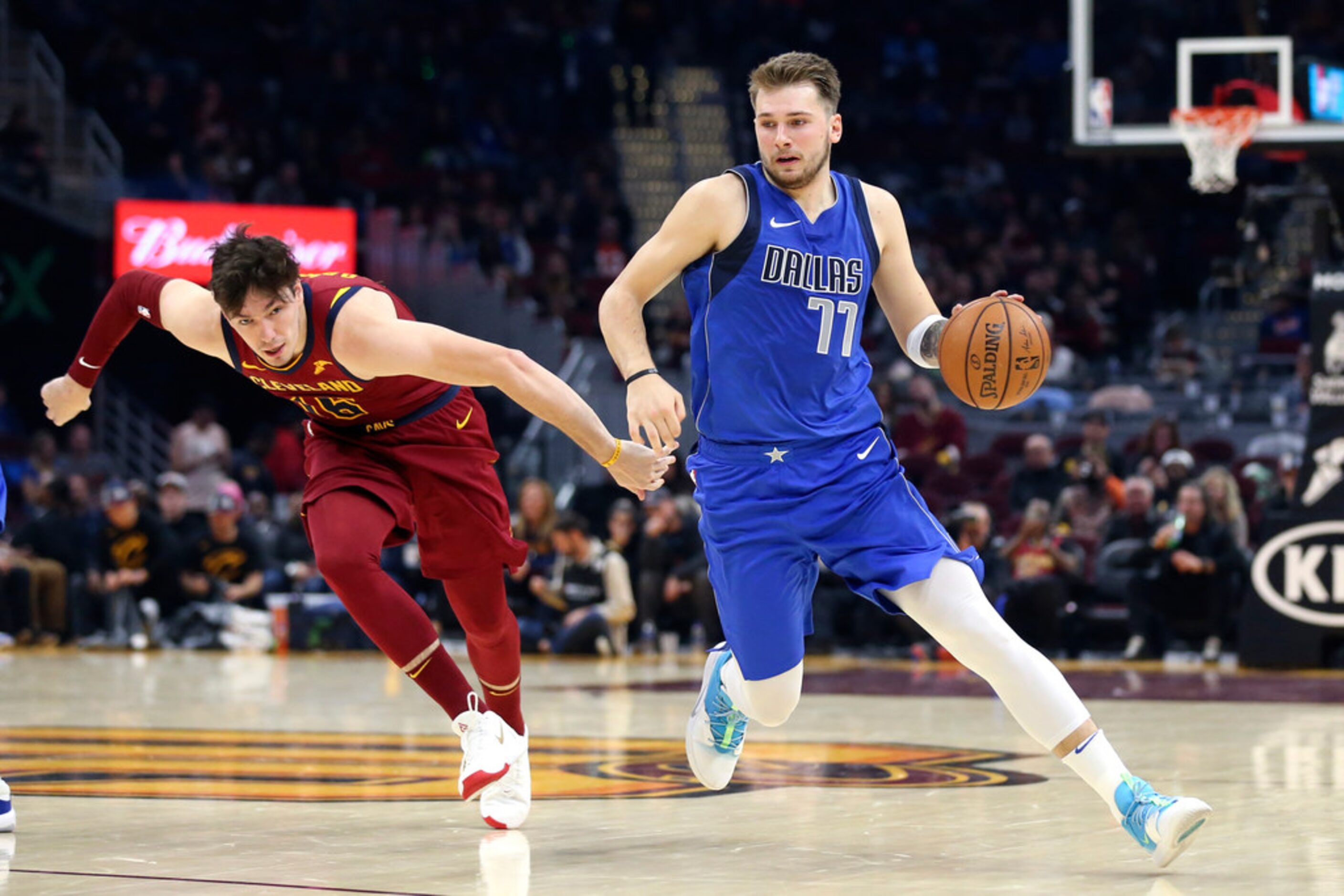 Dallas Mavericks' Luka Doncic (77) drives past Cleveland Cavaliers' Cedi Osman in the second...