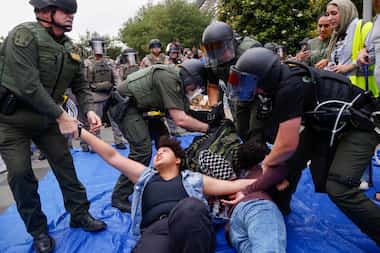 Law enforcement confronted an encampment of pro-Palestinian students and supporters at the...