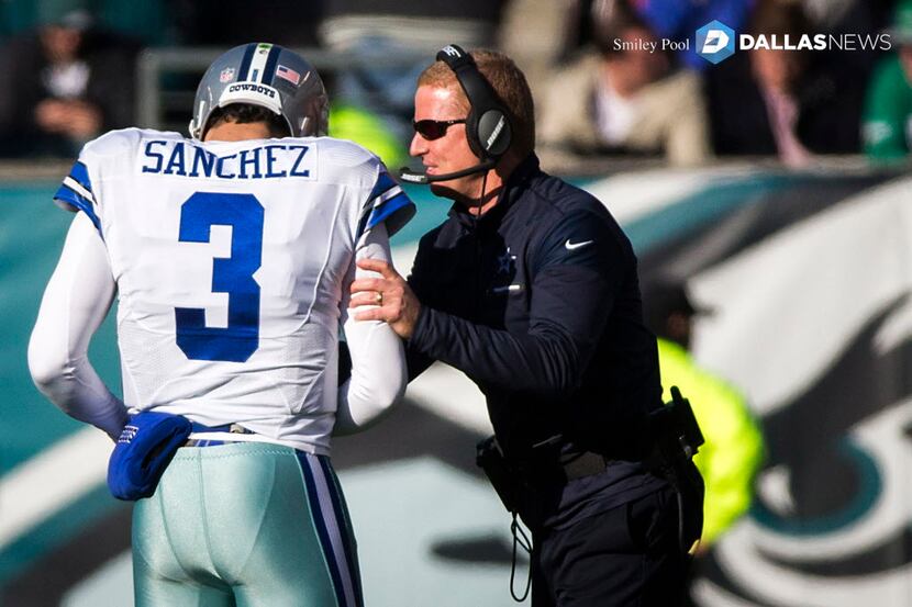 Dallas Cowboys quarterback Mark Sanchez (3) talks with head coach Jason Garrett as he checks...