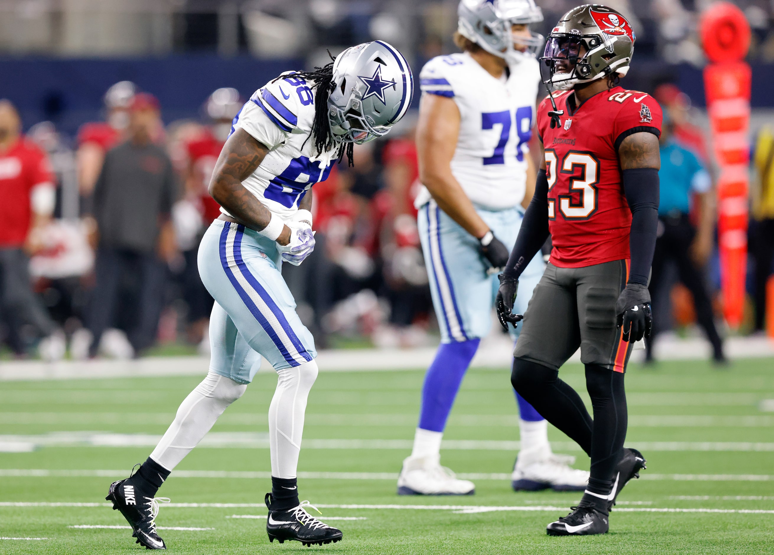 Dallas Cowboys wide receiver CeeDee Lamb (88) runs off the filed holding his shoulder...