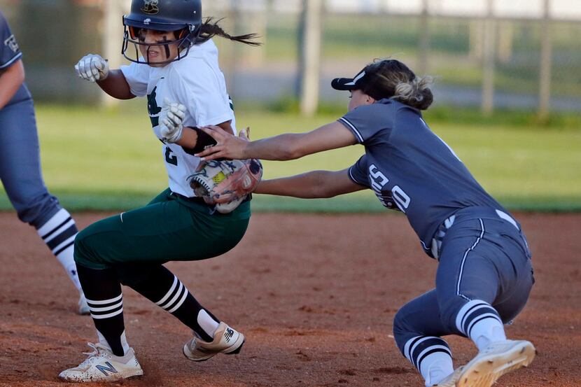 Birdville's Alicia Mora (left) is tagged out in a rundown by The Colony's Jayda Coleman...