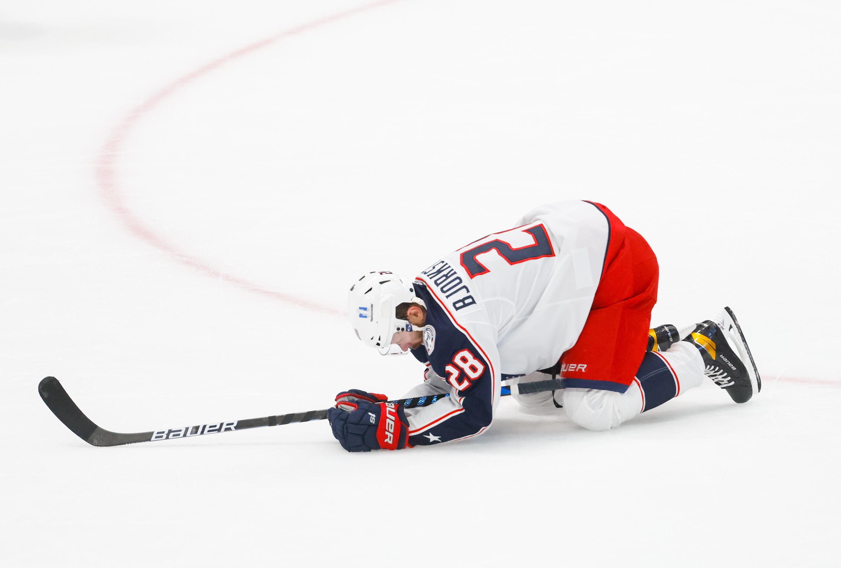 Columbus Blue Jackets right wing Oliver Bjorkstrand (28) stays on his knees after a fall in...